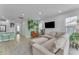 Bright living room with L-shaped sofa and accent chair at 9832 E Wavelength Ave, Mesa, AZ 85212