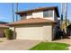 Two-story house with beige exterior, attached garage, and small lawn at 10036 W Montecito Ave, Phoenix, AZ 85037