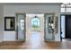 Bright entryway with double doors leading to a sunlit room and hardwood floors at 11124 E Del Timbre Dr, Scottsdale, AZ 85259