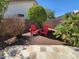 Landscaped backyard featuring two red Adirondack chairs and an artful arrangement of foliage at 11517 W Coral Snake Ct, Surprise, AZ 85378