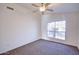 Well-lit bedroom with ceiling fan and window views at 11517 W Coral Snake Ct, Surprise, AZ 85378