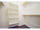 Spacious walk-in closet with built-in shelving and hanging rods at 11517 W Coral Snake Ct, Surprise, AZ 85378