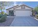 One-story house with a two-car garage and desert landscaping at 11517 W Coral Snake Ct, Surprise, AZ 85378