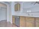 View of the kitchen featuring laminate floors, stainless steel appliances and light-colored countertops at 11517 W Coral Snake Ct, Surprise, AZ 85378