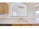 Kitchen with double sink and pass-through to living room at 11517 W Coral Snake Ct, Surprise, AZ 85378