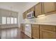 Eat-in kitchen with wood cabinets, a breakfast nook, and a view to backyard at 11517 W Coral Snake Ct, Surprise, AZ 85378