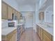 Bright kitchen boasts stainless steel appliances, wooden cabinets, and laminate floors at 11517 W Coral Snake Ct, Surprise, AZ 85378