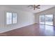 Bright living room featuring hardwood floors and sliding glass doors at 11517 W Coral Snake Ct, Surprise, AZ 85378