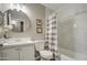 Clean bathroom with marble shower and white vanity at 12533 W Windsor Ave, Avondale, AZ 85323