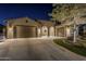 Beautiful home exterior at night, showcasing architectural details and landscaping at 13455 W Miner Trl, Peoria, AZ 85383