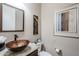 Modern powder room with a unique vessel sink and granite countertop at 13455 W Miner Trl, Peoria, AZ 85383