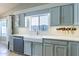 Kitchen with farmhouse sink, light blue cabinets, and quartz countertops at 1374 S Silverado St, Gilbert, AZ 85296