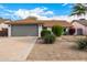 Single-story home with gray garage door and landscaped front yard at 15425 N 63Rd St, Scottsdale, AZ 85254