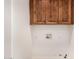 Laundry room with wood cabinets and hookups at 15425 N 63Rd St, Scottsdale, AZ 85254