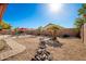 Landscaped backyard with gravel pathway and rock features at 16581 W Washington St, Goodyear, AZ 85338