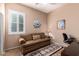 Bright bedroom featuring a comfortable sofa and window seating at 16581 W Washington St, Goodyear, AZ 85338