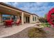 Covered patio with seating area, fountain, and landscaping at 1684 E Elysian Pass, Queen Creek, AZ 85140