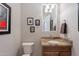 Elegant powder room with granite vanity and framed artwork at 1684 E Elysian Pass, Queen Creek, AZ 85140