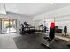 Home gym with equipment and access to a back patio at 16919 E Nicklaus Dr, Fountain Hills, AZ 85268