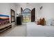 Spacious bedroom with large windows, plantation shutters and a TV at 20177 E Via De Arboles --, Queen Creek, AZ 85142