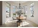 Bright dining area with round table and modern chairs, featuring large windows at 20177 E Via De Arboles --, Queen Creek, AZ 85142