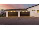 Two-car garage with dark brown doors and paved driveway at 20177 E Via De Arboles --, Queen Creek, AZ 85142