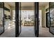 View through glass doors to a covered patio with dining table, and a glimpse of a pool beyond at 20177 E Via De Arboles --, Queen Creek, AZ 85142