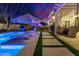 Night view of a patio with pool, lounge chairs, and hanging swing at 20177 E Via De Arboles --, Queen Creek, AZ 85142