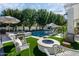 Inviting backyard oasis with a sparkling pool, fire pit, and comfortable seating area at 20177 E Via De Arboles --, Queen Creek, AZ 85142