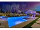 Night view of a large, illuminated pool with spa and lounge chairs at 20177 E Via De Arboles --, Queen Creek, AZ 85142