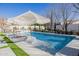 Relaxing pool area with a swim-up tanning ledge and patio chairs at 20177 E Via De Arboles --, Queen Creek, AZ 85142