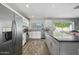 Bright kitchen featuring stainless steel appliances and an island at 2244 S Estrella Cir, Mesa, AZ 85202