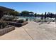 Outdoor community pool area with plenty of seating, umbrellas, and shade at 2327 W Firethorn Way, Anthem, AZ 85086