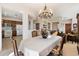 Open dining area with chandelier, and views into living room and kitchen at 2327 W Firethorn Way, Anthem, AZ 85086