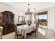 Elegant dining room with chandelier, large windows, and hardwood floors at 2327 W Firethorn Way, Anthem, AZ 85086