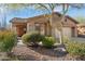 One-story house with tan exterior, landscaped yard, and two-car garage at 2327 W Firethorn Way, Anthem, AZ 85086