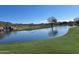 Scenic golf course view featuring a tranquil pond and a charming waterfall at 2327 W Firethorn Way, Anthem, AZ 85086