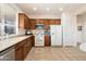 Well-equipped kitchen with wood cabinets, tile floors and modern appliances at 2327 W Firethorn Way, Anthem, AZ 85086