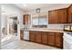 Bright kitchen with wood cabinets, stainless steel appliances, and tile flooring at 2327 W Firethorn Way, Anthem, AZ 85086