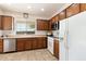 Kitchen features ample wood cabinetry, stainless steel appliances, and tile floors at 2327 W Firethorn Way, Anthem, AZ 85086