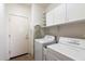 Laundry room with washer, dryer, and extra storage at 2327 W Firethorn Way, Anthem, AZ 85086