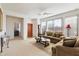 Bright and airy living room with comfortable seating and access to other rooms at 2327 W Firethorn Way, Anthem, AZ 85086