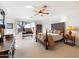 Spacious main bedroom with wood furniture, ceiling fan, and large window at 2327 W Firethorn Way, Anthem, AZ 85086