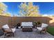 Relaxing patio with fire pit and comfortable seating at 25151 N 143Rd Dr, Surprise, AZ 85387