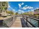 Wooden boardwalk extending over a calm lake at 2722 S Cavalier Dr # 102, Gilbert, AZ 85295