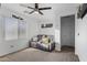 Bedroom with ceiling fan, gray couch and window blinds at 2747 E Megan St, Gilbert, AZ 85295