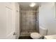 Updated bathroom with gray tile shower and pedestal sink at 310 W Aspen Ave, Gilbert, AZ 85233