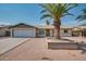 Cute ranch home with a large front yard and a beautiful palm tree at 341 W 23Rd Ave, Apache Junction, AZ 85120