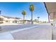 Gravel backyard with a covered patio and palm trees at 3605 W Bethany Home Rd # 10, Phoenix, AZ 85019