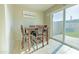 Bright dining area with a four-person table and access to backyard at 3605 W Bethany Home Rd # 10, Phoenix, AZ 85019